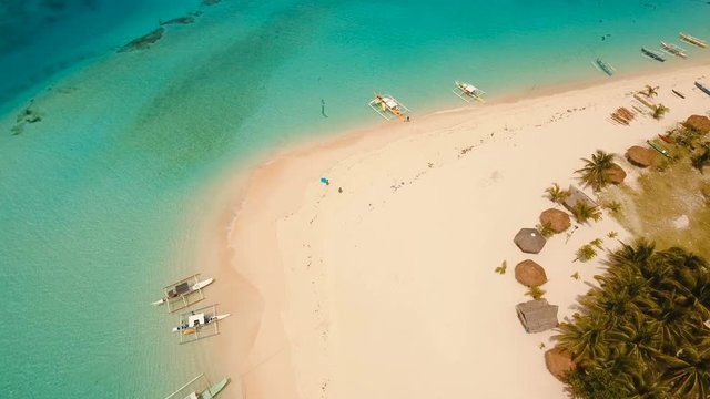 Aerial view of beautiful tropical island Daco with white sand beach. View of a nice tropical beach from the air. Beautiful sea, resort. Seascape: Ocean and beautiful beach paradise. Philippines. 4K