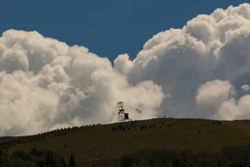 Beautiful Gold Mine in Cripple Creek Colorado with billowing storm clouds in the background.