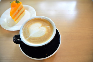 Coffee and orange cake on wooden table