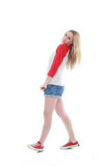 full length portrait of a blonde girl wearing casual t-shirt and denim shorts. isolated on white background.