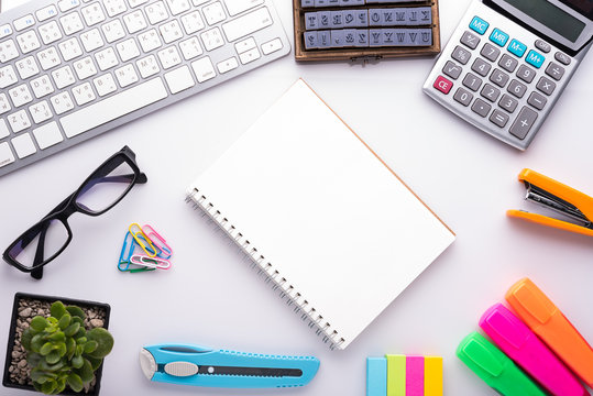 White office desk table with school accessories with office supplies. Top view with copy space