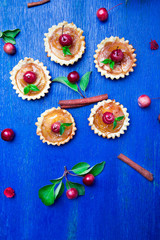 Apple caramel little tarts on blue rustic background. French tatin with paradise apple. Top view