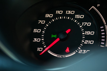 Speedometer with red speed arrow.