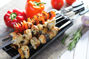 Kebab cooked on metal skewers with vegetables