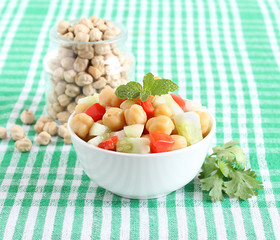 Homemade Indian food, a healthy salad called chana chaat, made from chickpea, tomato, onion and cucumber, in a bowl.