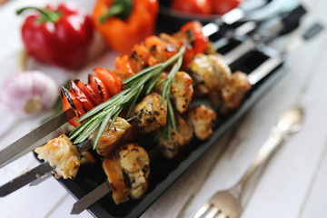 Kebab cooked on metal skewers with vegetables