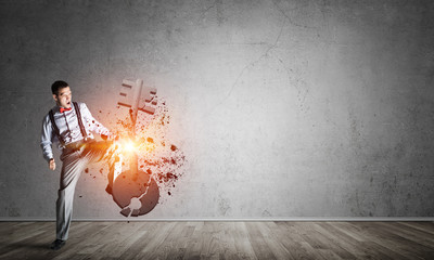 Breaking through access concept with man in room crashing concrete key