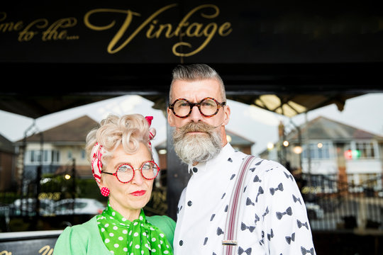 Serious Portrait Of A Quirky Vintage Couple Outside Vintage Shop