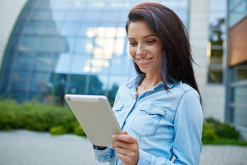 Smiling young pretty woman with tablet.