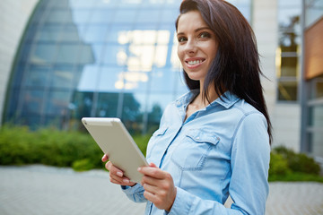 Smiling young pretty woman with tablet.