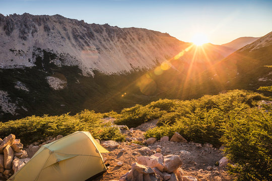 Tent in mountain landscape at sunset, Nahuel Huapi National Park, Rio Negro, Argentina