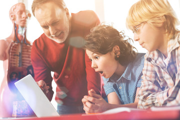 Delighted teacher pointing at necessary task