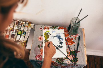 Female artist painting picture on notepad © Jacob Lund