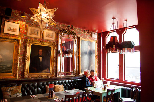 Quirky couple relaxing in bar and restaurant, Bournemouth, England
