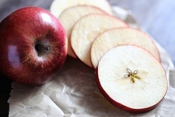 Red fresh apple on a wooden table
