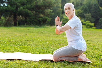 Fototapeta premium Delighted woman preparing for meditation