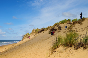 Fototapeta na wymiar Sand dunes and climbing childen