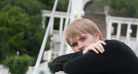 Portrait of attractive young man outdoors, looking at camera