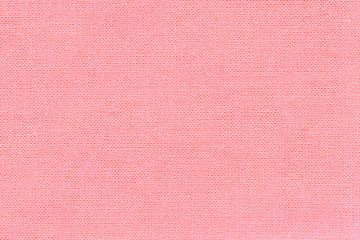 Light pink background from a textile material with wicker pattern, closeup.
