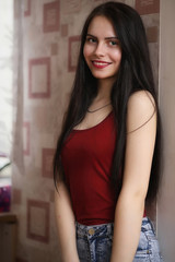 Fototapeta premium Pretty girl posing at camera in apartment