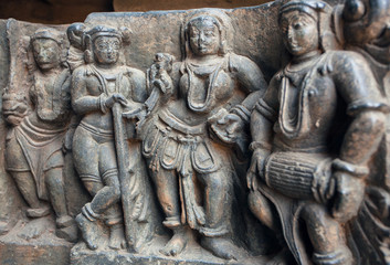 Old stone sculpture with drummer and people listening music. Relief of the 12th century Hoysaleshwara temple in Halebidu, India