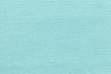 Light blue background from a textile material with wicker pattern, closeup.