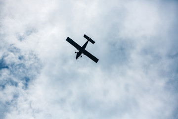 airplane flying in cloudy sky, Bottom view angle of air plane flying in the sky, Retro style airplane