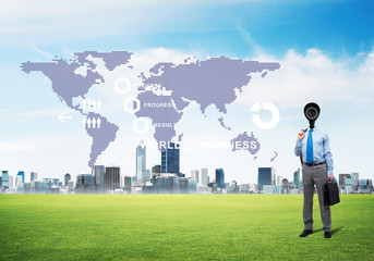 Camera headed man standing on green grass against modern cityscape