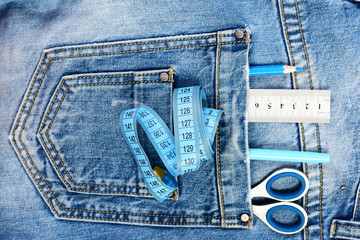Tailors tools with denim textile: tailoring and design concept