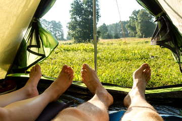 View from the tent to the wild, river meadow, forest and legs