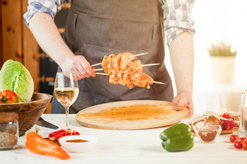 male preparing chicken for cooking