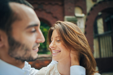 beautiful wedding couple hugging standing near old building