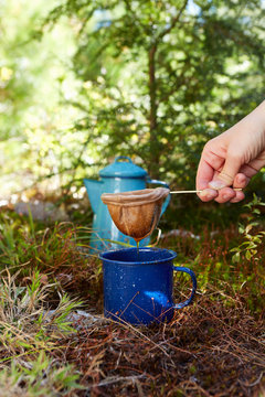 Woman making coffee in forest, close-up, Colgate Lake Wild Forest, Catskill Park, New York State, USA