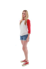 full length portrait of a blonde girl wearing casual t-shirt and denim shorts. isolated on white background.