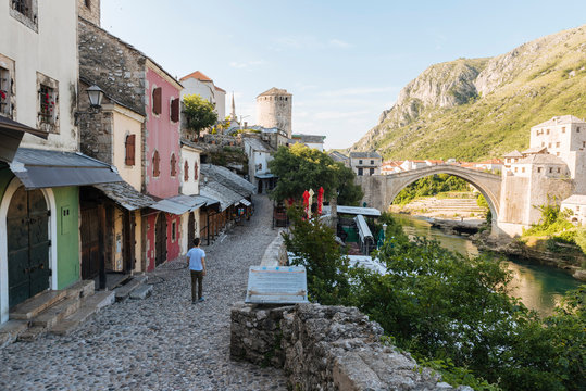 Rear view of man walking up street, Mostar, Bosnia and Herzegovina, Europe