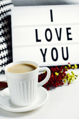 cup of coffee and text I love you in a lightbox