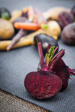Selection of vegetables, beetroot cut in half in foreground, close-up