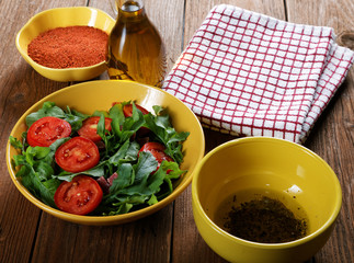 Vegetable salad with tomatoes and arugula on the table