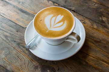 cappuccino cup on the brown wooden table