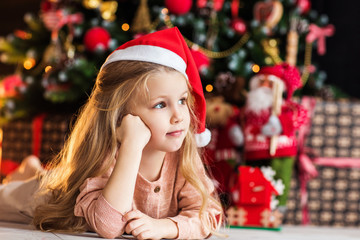 Little cute girl near christmas tree