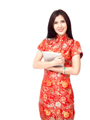 Chinese new year woman concept, isolated asian woman wearing red dress holding tablet