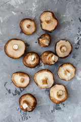 Fresh raw organic Shiitake Mushrooms is cooking ingredient for hot chilly asian soups pn marble stone surface. Healthy vegetarian food. Top view. Kitchen concept. Thailand and Vietnam cuisine.
