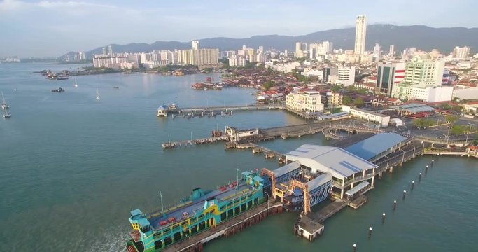 Car Ferry Docked at Georgetown Pier, Penang, Malaysia, Aerial Pullback Shot
