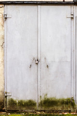 Old gray steel doors on a wall