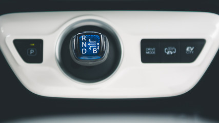 Gearbox knob in the hybrid car and drive modes buttons.