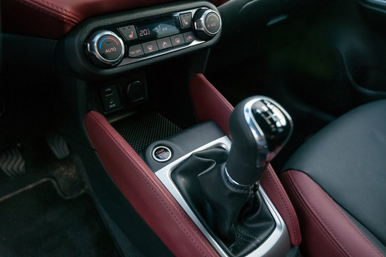 Gear shifter, engine start button and climate control system.