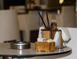 Table set and ashtray on the table of a street bar