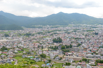 Ariel view of small town with mountain in background, Shimoyoshida in Yamanashi, Japan.