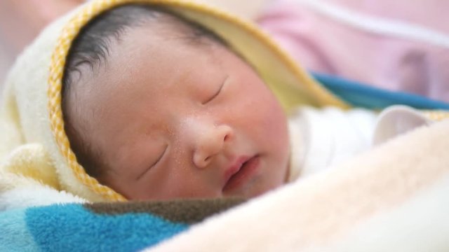 A Japanese baby sleeping right after she was born