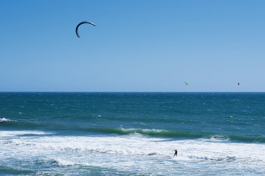 Remote view at kite surfers riding the waves in Santa Cruz, California